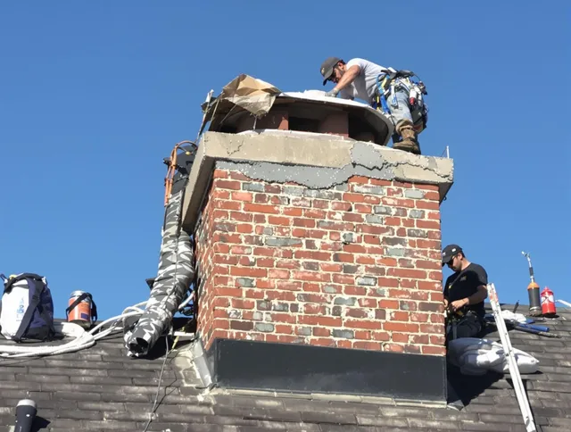 Concord Chimney Sweep installing a custom chimney crown in Concord, MA