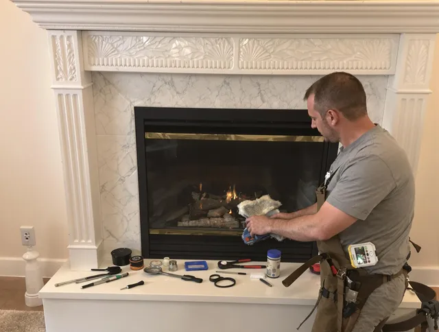 Concord Chimney Sweep performing fireplace maintenance in Concord, MA